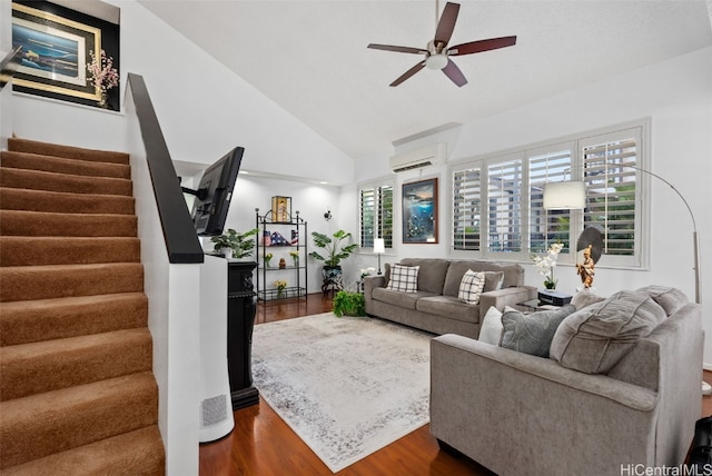 living room with dark hardwood / wood-style flooring, high vaulted ceiling, a wall mounted AC, and ceiling fan