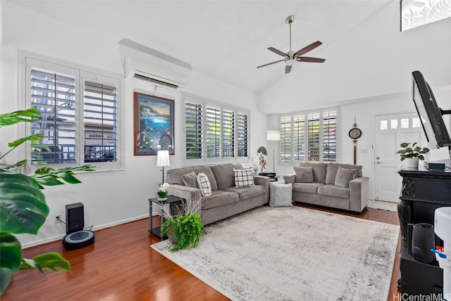 living room with a wall mounted air conditioner, ceiling fan, dark hardwood / wood-style floors, and high vaulted ceiling