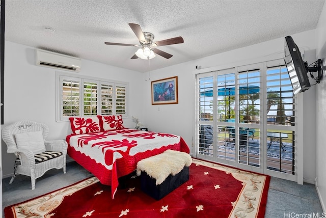 bedroom featuring carpet, a textured ceiling, a wall mounted AC, and ceiling fan