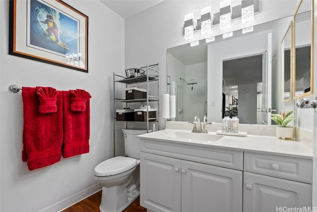 bathroom featuring hardwood / wood-style floors, vanity, toilet, and a shower with door