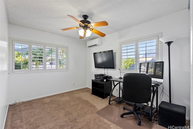 home office featuring an AC wall unit, carpet flooring, a healthy amount of sunlight, and a textured ceiling