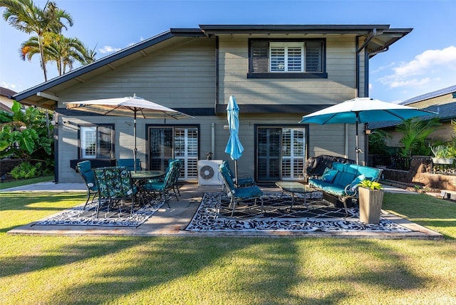 rear view of house with a lawn, an outdoor living space, ac unit, and a patio