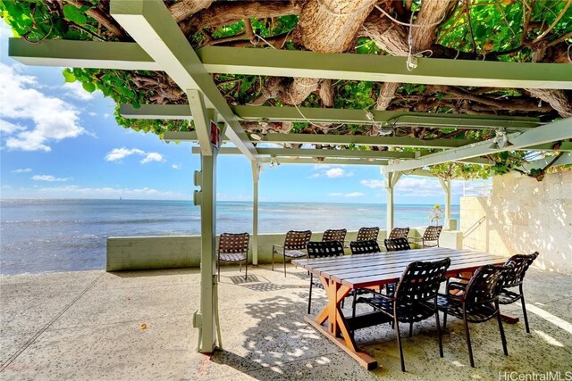 view of patio / terrace with a pergola and a water view