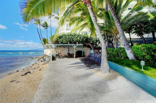 view of patio / terrace featuring a beach view and a water view