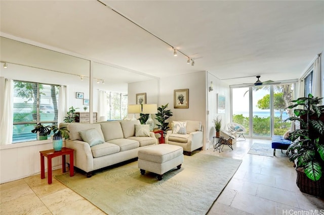 living room with ceiling fan and rail lighting