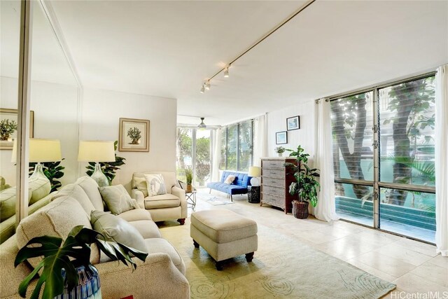 living room featuring ceiling fan, expansive windows, and track lighting