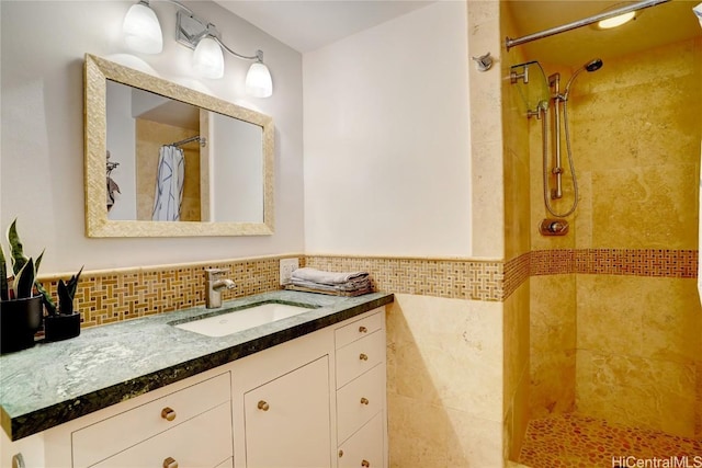 bathroom featuring vanity, walk in shower, and tile walls