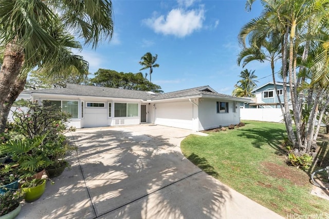 ranch-style home with a garage, fence, concrete driveway, stucco siding, and a front lawn