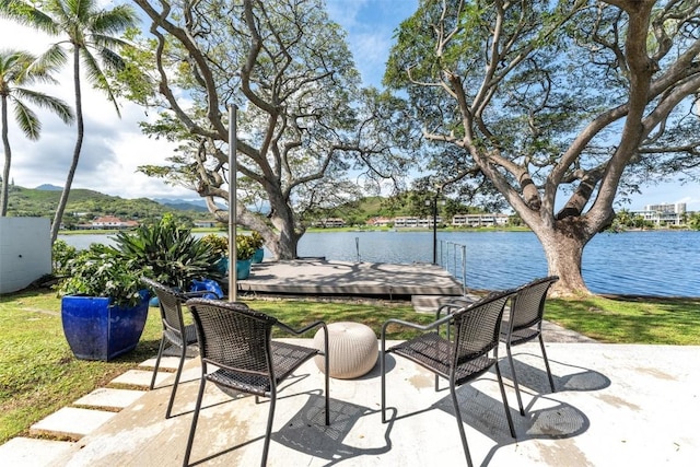 view of patio / terrace with a dock and a water view