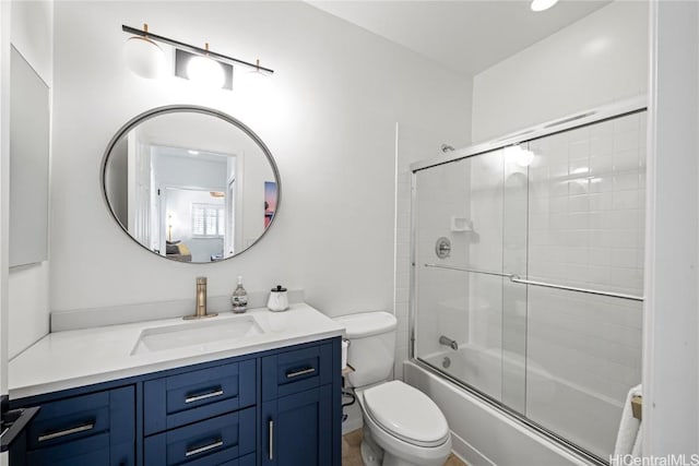 full bathroom with toilet, vanity, and shower / bath combination with glass door