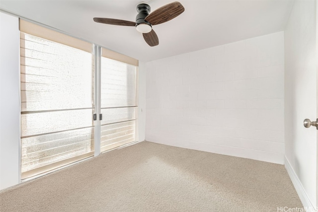 empty room with ceiling fan and carpet floors