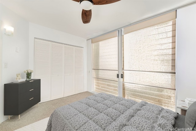 carpeted bedroom with a closet and ceiling fan