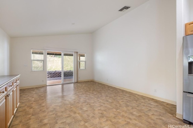 unfurnished living room with lofted ceiling