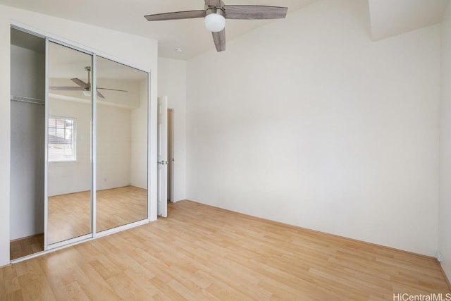 unfurnished bedroom with light hardwood / wood-style flooring, a closet, and ceiling fan