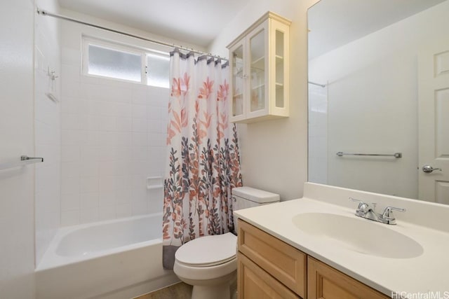 full bathroom with shower / bath combo with shower curtain, vanity, and toilet