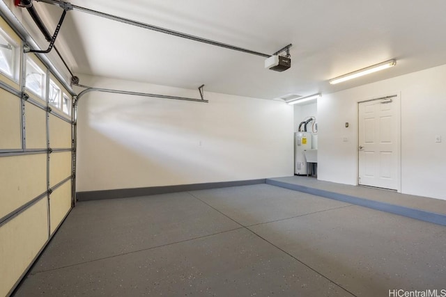 garage featuring electric water heater and a garage door opener