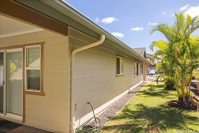 view of side of home featuring a yard