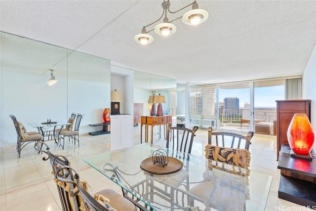 dining space with a textured ceiling, light tile patterned floors, and expansive windows