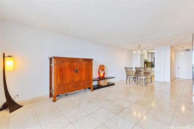 dining room featuring a textured ceiling and light tile patterned flooring