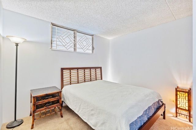 bedroom featuring carpet and a textured ceiling