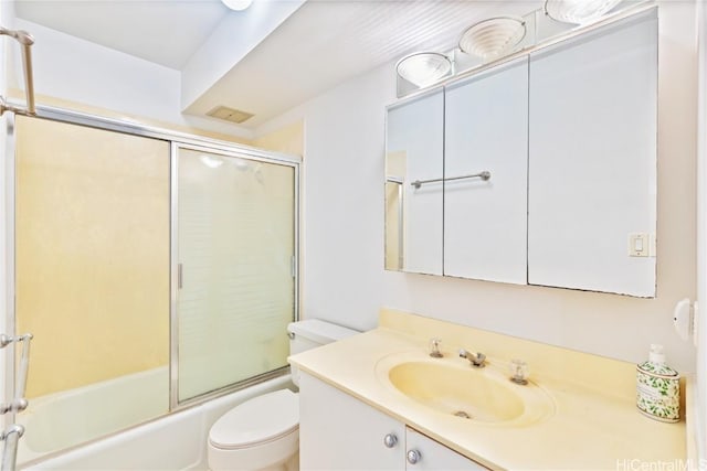 full bathroom with toilet, vanity, and shower / bath combination with glass door