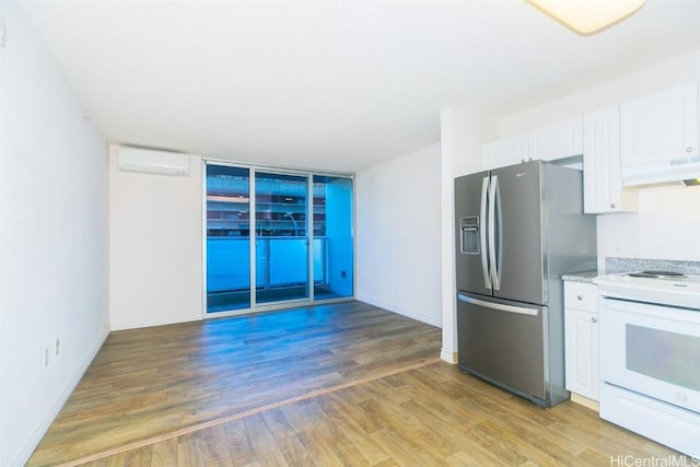 kitchen with a wall mounted air conditioner, wood-type flooring, electric range, stainless steel fridge with ice dispenser, and white cabinetry