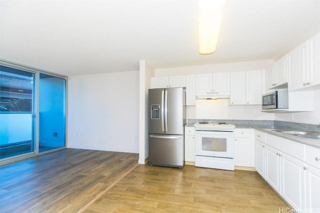 kitchen with white cabinets, stainless steel appliances, light hardwood / wood-style floors, and sink