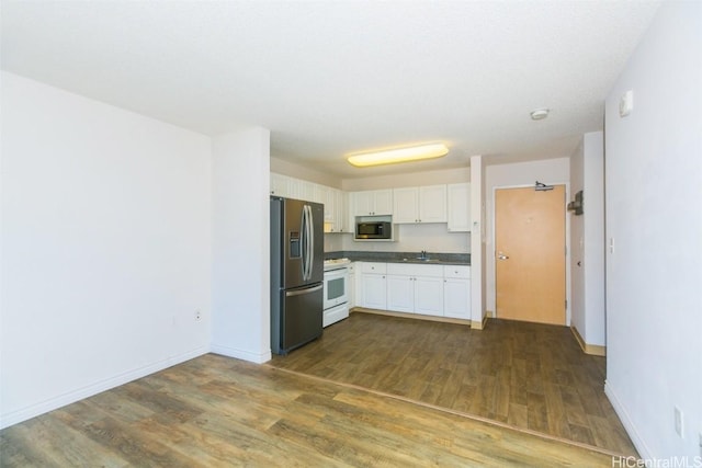 kitchen with white cabinets, dark hardwood / wood-style flooring, sink, and appliances with stainless steel finishes