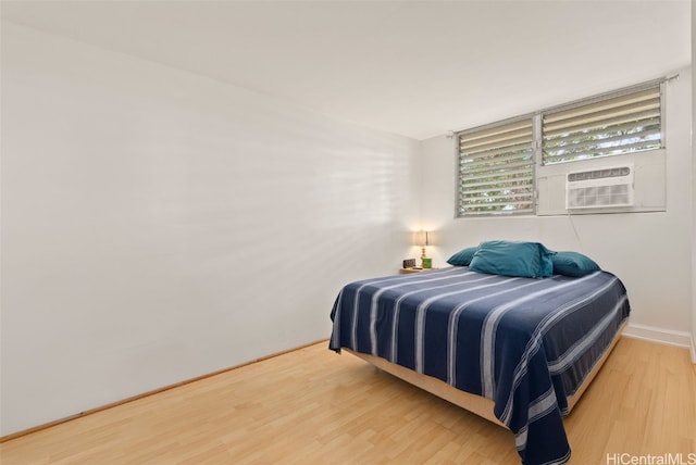 bedroom featuring cooling unit and hardwood / wood-style flooring