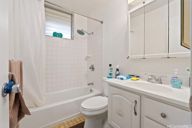 full bathroom featuring tile patterned flooring, toilet, vanity, and shower / bath combo with shower curtain