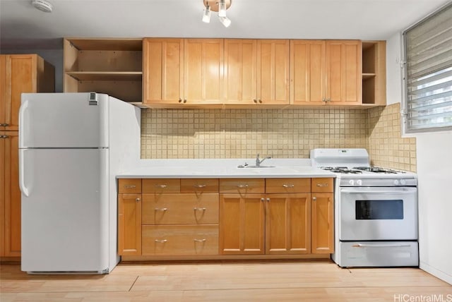 kitchen with white appliances, light hardwood / wood-style flooring, and backsplash