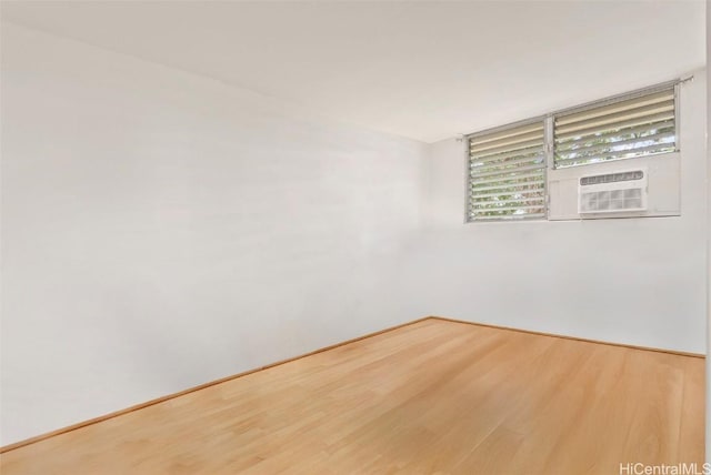 spare room featuring hardwood / wood-style floors and cooling unit