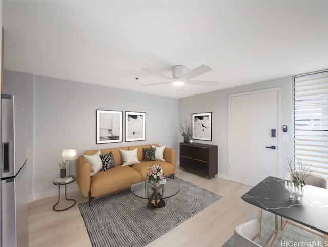 living room with ceiling fan and light wood-type flooring