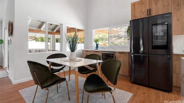 dining room featuring light wood-type flooring and wine cooler