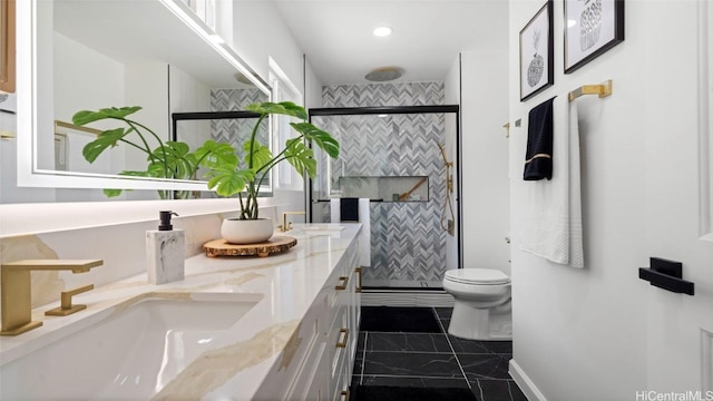 bathroom featuring vanity, toilet, and walk in shower