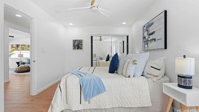 bedroom with ceiling fan, a closet, and hardwood / wood-style floors