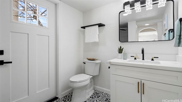 bathroom featuring tile patterned floors, vanity, and toilet