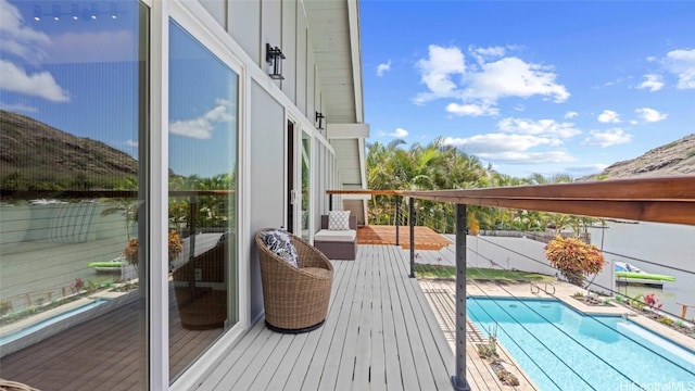 wooden deck featuring a fenced in pool