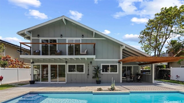 back of house with a fenced in pool and a patio area