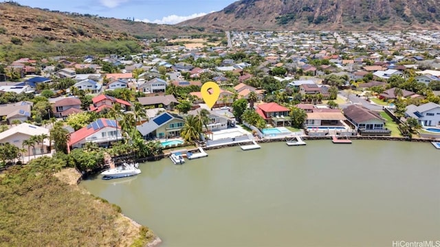 birds eye view of property with a water and mountain view