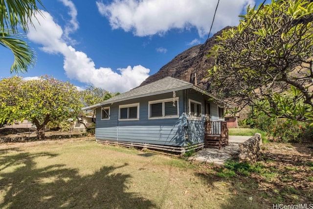 view of side of home with a yard