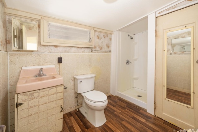 bathroom featuring hardwood / wood-style flooring, sink, a shower, and toilet