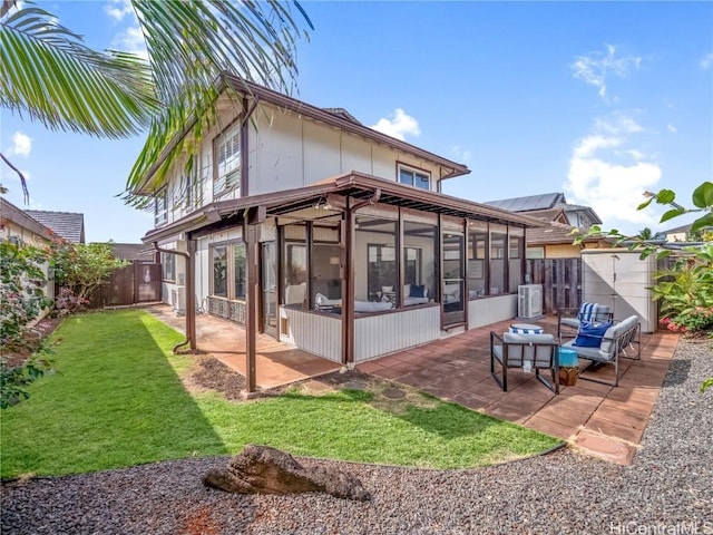 back of house featuring a patio, outdoor lounge area, central AC, a sunroom, and a yard