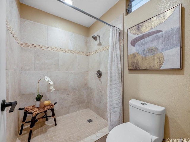 bathroom with toilet and a shower with shower curtain