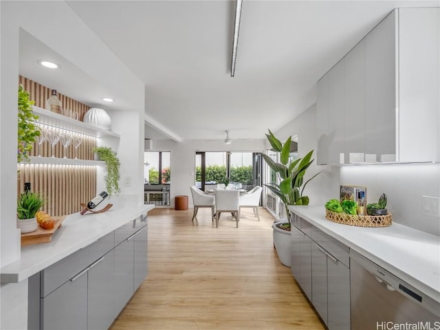 interior space featuring gray cabinetry, ceiling fan, stainless steel dishwasher, and light wood-type flooring