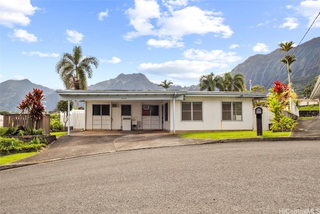 ranch-style home with a mountain view and a carport