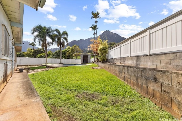 view of yard featuring a mountain view and a shed