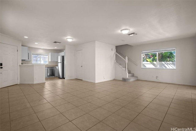 unfurnished living room with light tile patterned floors