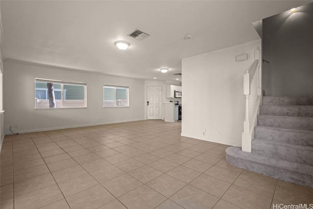 unfurnished living room featuring light tile patterned flooring