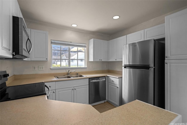 kitchen with stainless steel appliances, recessed lighting, white cabinetry, and a sink